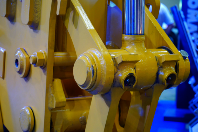 A close up of a hydraulic piston system to show the principles of hydraulic power systems.