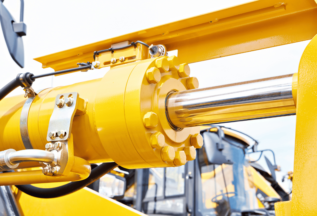 Yellow hydraulic cylinder being used on a tractor.