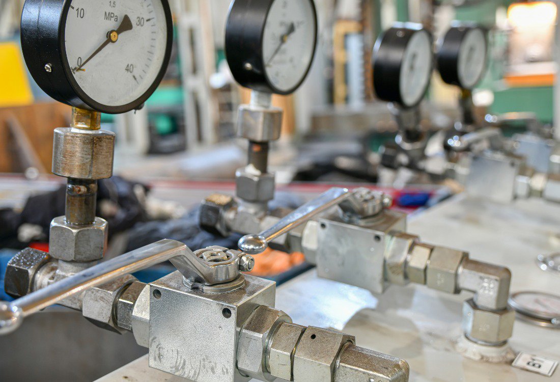 Professional hydraulic-pressure-testing-equipment setup featuring multiple pressure gauges and precision valves for electro-hydraulic system calibration and testing.