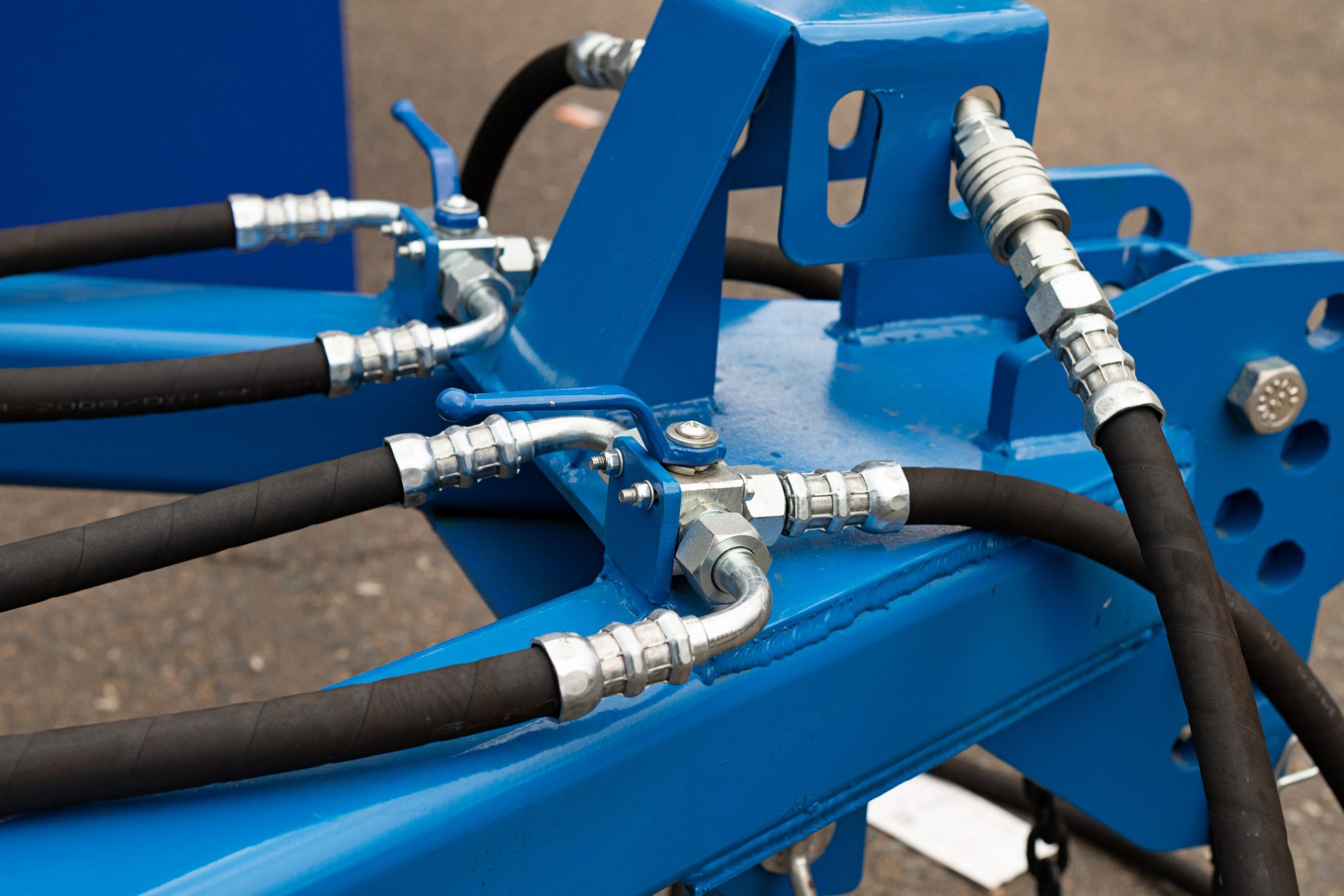 Spill Control Equipment installed on hydraulic machinery with hoses and fittings to support safe fluid handling and reduce leak risks.